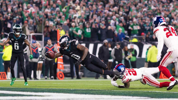 Dec 25, 2023; Philadelphia, Pennsylvania, USA; Philadelphia Eagles running back D'Andre Swift (0) scores a touchdown past New York Giants safety Xavier McKinney (29) during the fourth quarter at Lincoln Financial Field.